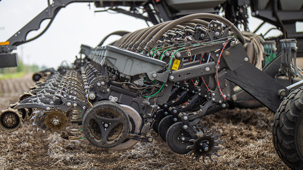 Close-up of Fendt Momentum planter row units showcasing precision AGCO planting technology and high-efficiency components.