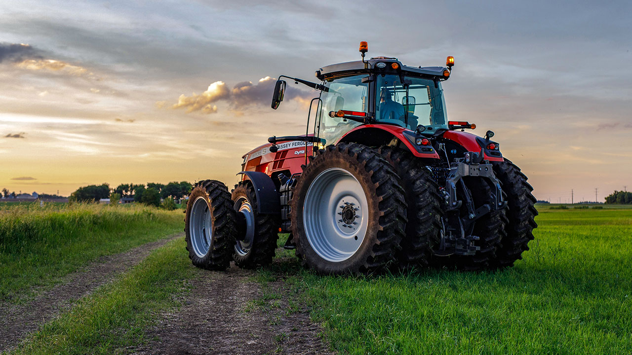 Massey Ferguson 8700S tractor with dual rear wheels parked on a rural path at sunset, built for heavy-duty field performance.