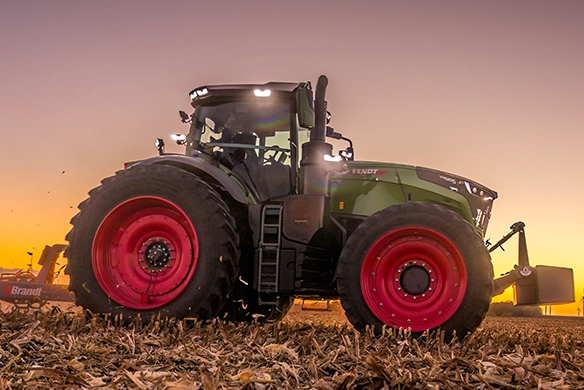 Thumbnail for Fendt 1000 Vario tractor working with Brandt tillage equipment in a field at sunset.