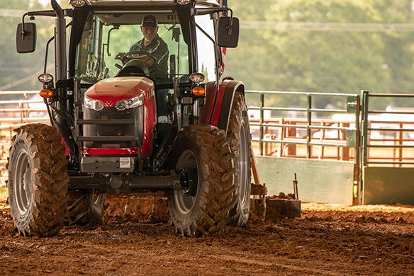 Massey Ferguson 4700 Series utility tractor working blading dirt in an areana.