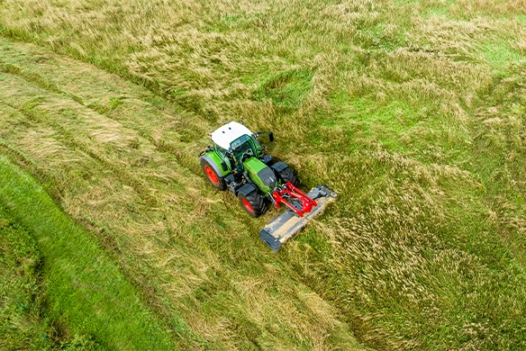 Aerial view of Massey Ferguson DM367 Front Mower efficiently cutting grass with a Fendt tractor.
