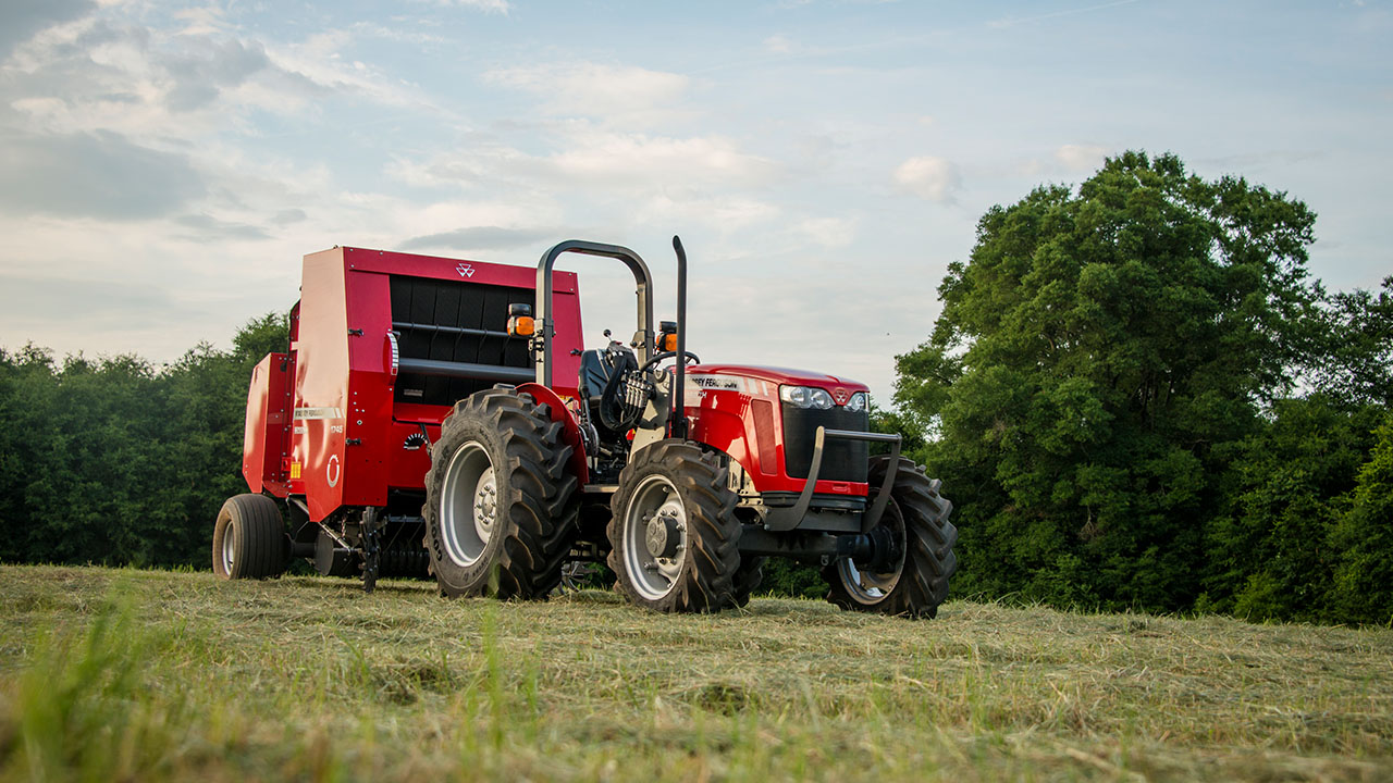 Thumbnail for Hesston by Massey Ferguson 1700 Series round baler in hay field, built for efficiency and performance in baling operations.