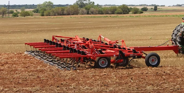Kuhn 4000 chisel plow at work in a field of stubble.