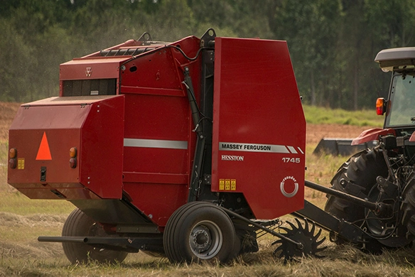 Hesston by Massey Ferguson 1700 Series round baler in operation, ideal for small farms needing reliable hay baling performance.