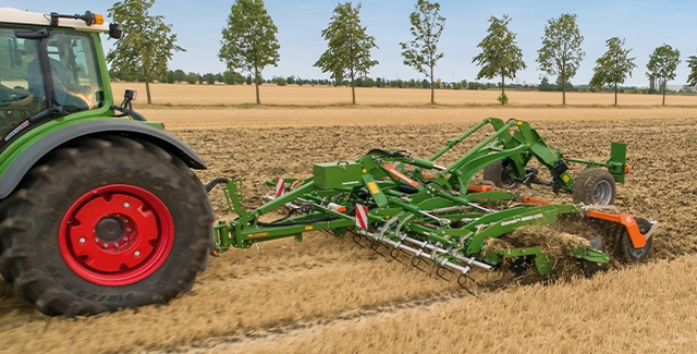 Amazone CatrosXL 6003 tillage being pulled through field by a Fendt tractor.