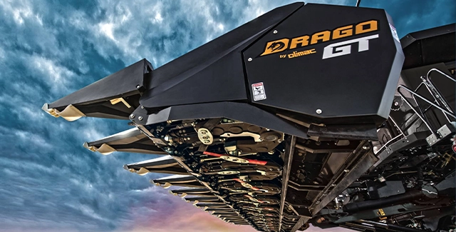 Detailed underside view of the Drago GT corn head, showcasing precision engineering, deck plate design, and gear-driven row units.