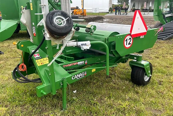 Green CANAG Twister PRO 520 agricultural machine designed for bale wrapping on display at a trade show.