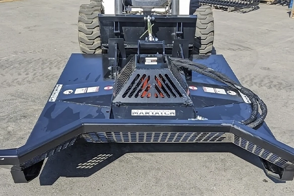 Heavy-duty Martatch brush cutter skid steer attachment with reinforced steel deck and safety guards.