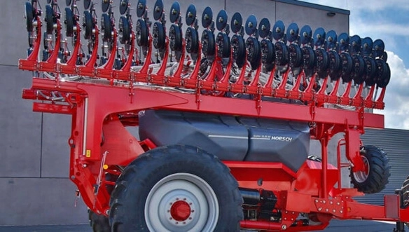 HORSCH Avatar seeder shown in folded transport position with row units raised, featuring large seed hopper and heavy-duty frame on display.