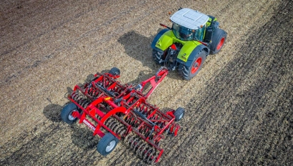 Overhead view of HORSCH Joker RX pulled by CLAAS tractor during tillage, revealing full working width and even surface cultivation.