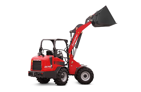 Schäffer 4670Z articulated wheel loader with raised general-purpose bucket attachment, designed for compact performance and versatility.