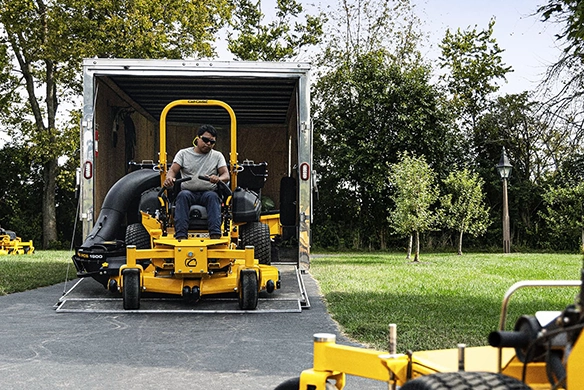 Front view of a Cub Cadet zero-turn mower being unloaded from a trailer