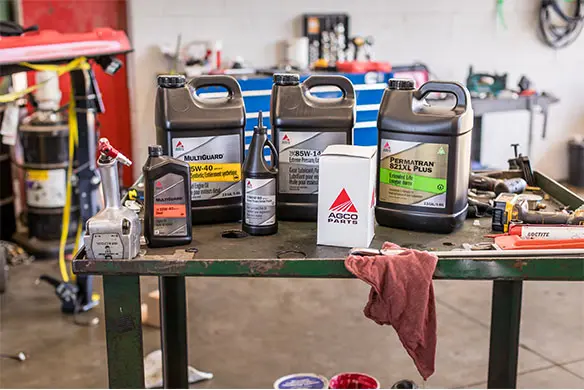 Genuine AGCO Parts oils, lubricants, and filters on service bench – save on genuine AGCO fluids and maintenance products.