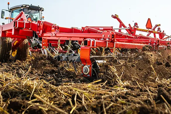 Tillage equipment working soil with Massey Ferguson tractor – limited-time savings on genuine AGCO tillage parts.
