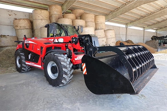 Faresin Heavy Duty telehandler with high-capacity bucket attachment working indoors near hay bales.