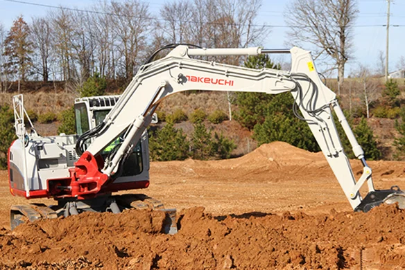 Takeuchi TB2150 compact hydraulic excavator digging at a jobsite, ideal for heavy-duty construction work.