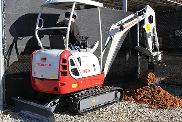 Compact Takeuchi TB216 mini excavator with open cab, shown on pavement ready for landscaping or utility work.