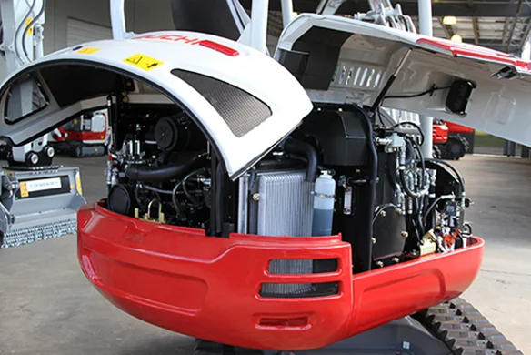Open engine compartment of Takeuchi TB225 showing internal components and easy service access.