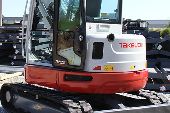 Side view of Takeuchi TB257FR excavator showcasing compact design and enclosed cab.