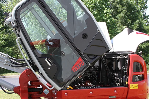 Tilted cab on the Takeuchi TB370 excavator, providing access to internal components for easy maintenance.