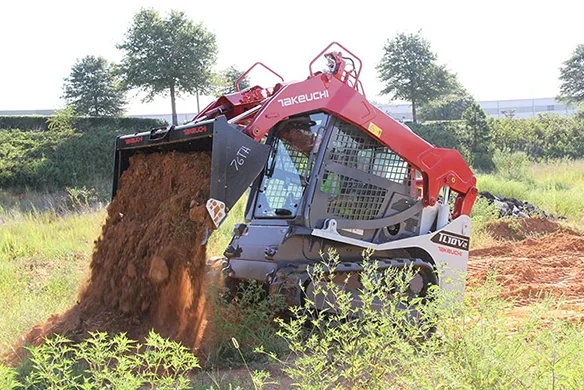 Thumbnail for Front view of Takeuchi TL10V2 loader lifting and dumping dirt on a grassy site.