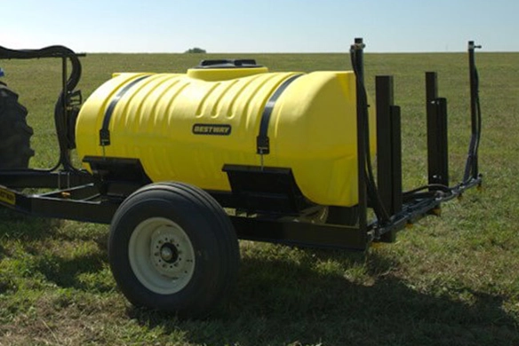 Close up side profile view of Bestway Ag trailer sprayer parked on a green field.