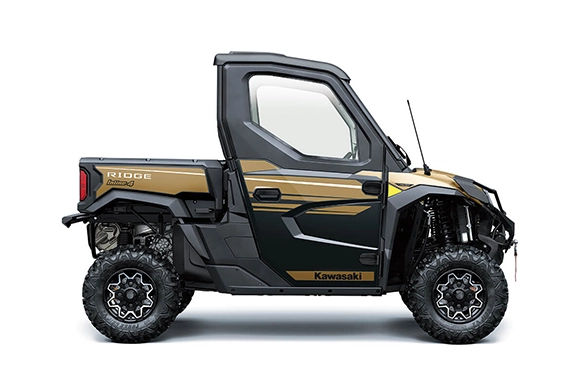 Front three-quarter view of a Kawasaki Ridge HVAC Limited edition in gold and black with rugged off-road tires and a front winch.