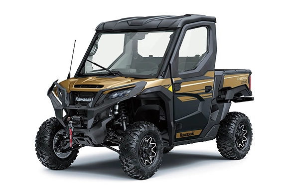 Rear three-quarter view of a gold and black Kawasaki Ridge HVAC Limited utility vehicle showing the cargo bed and suspension details.