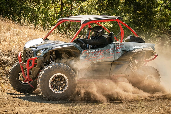 Kawasaki Teryx KRX 1000 powersliding on a dusty trail in off-road environment