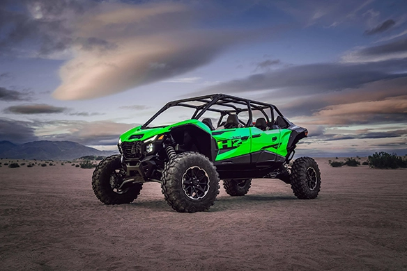 Kawasaki Teryx 4 H2 side-by-side with supercharged engine parked on desert terrain at dusk