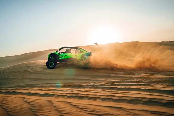 Kawasaki Teryx 5 H2 off-road UTV tearing through desert sand at sunris