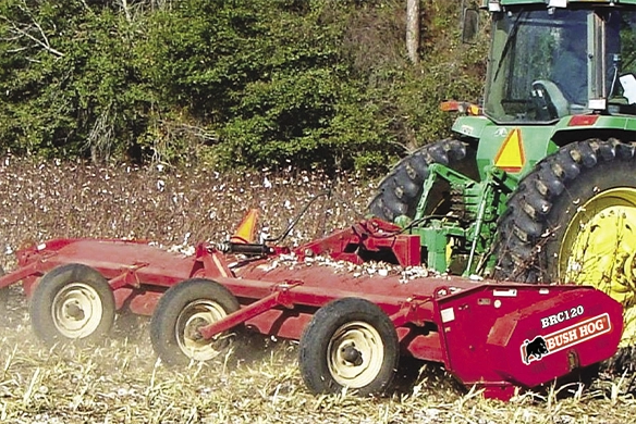 Bush Hog multi-spindle crop flail mower attached to a green tractor in a field