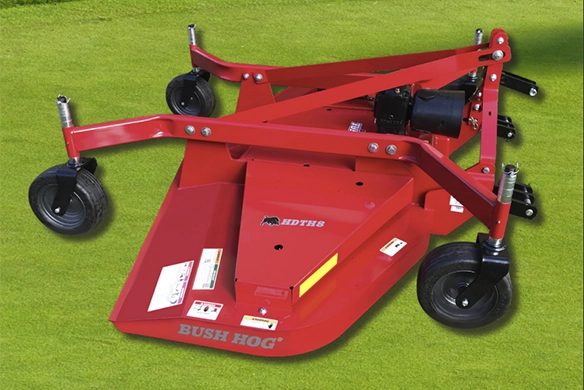 A red Bush Hog RDTH rear discharge finish mower positioned on a neatly cut lawn.