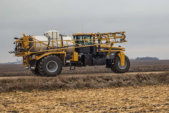 Side view of TerraGator liquid applicator driving on a dirt road