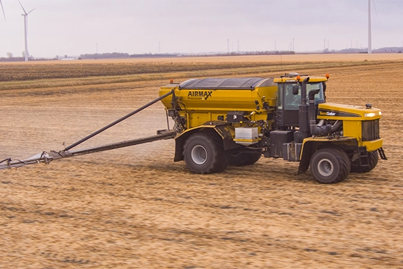 TerraGator AirMax dry application machine spreading fertilizer across a large farm field.