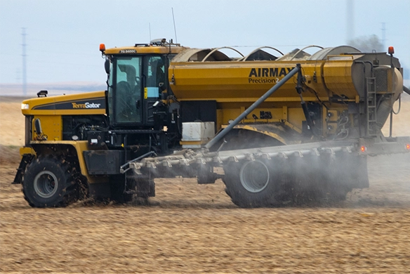 TerraGator AirMax Precision dry applicator spreading material evenly across farmland.