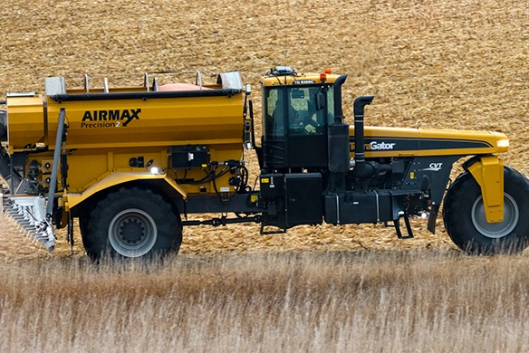TerraGator AirMax dry applicator moving through a farm field, side profile view.