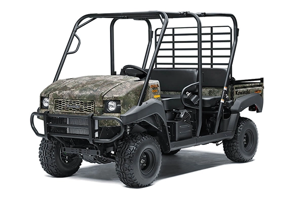 Front angled view of a Kawasaki Mule 4010 Trans 4x4 in camo finish, showcasing its extended cab and rugged off-road build.