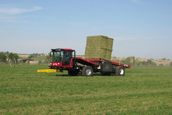 Mil-Stak bale stacker with square hay bales fully loaded in the field, ready for transport.