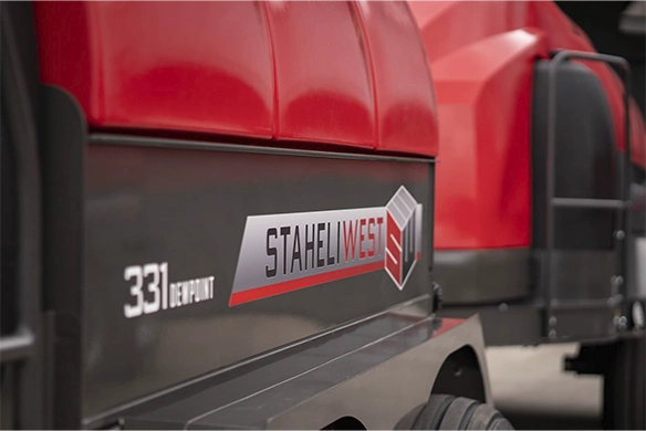 Close-up of Staheli West DewPoint 331 logo on side of red hay steamer.