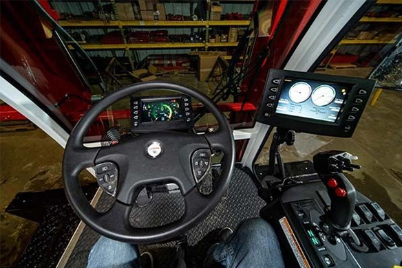 Operator's view of the Stinger 6500 cab interior, showing controls and steering wheel.