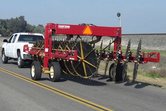 DARF 1017 rake folded in transport mode on the road behind a pickup truck