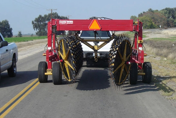 Rear view of DARF 1017 rake in transport configuration behind a white truck