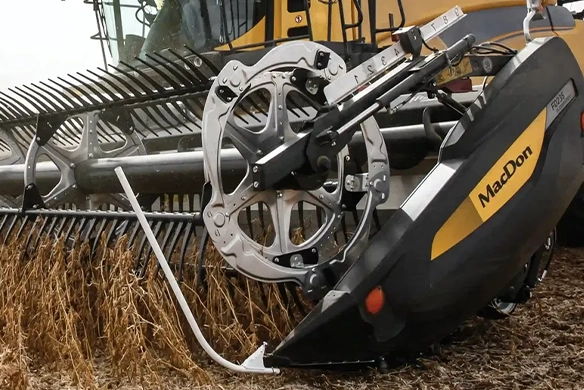 Close-up of MacDon FD2 header collecting crops during harvest.