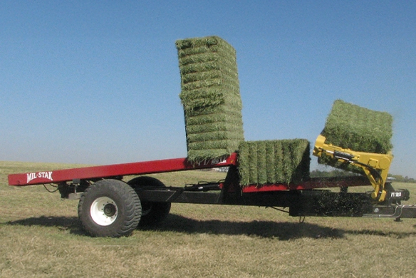 Mil-Stak PT/2150 pull-type bale stacker in action, collecting hay bales.