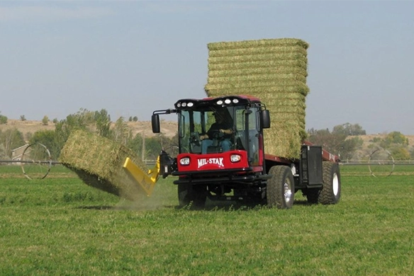 Mil-Stak self-propelled unit stacking multiple bales on a field.