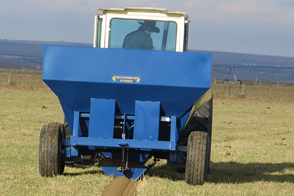 Rear view of OTECO track filler in action, filling tire ruts behind tractor