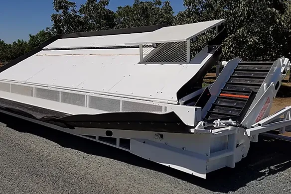 Weldcraft Industries continuous flow receiver for nut harvesting systems, enabling smooth transfer of product from harvester to transport unit.