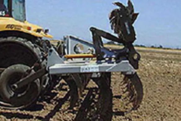 Wilcox finishing chisel with heavy-duty vertical shanks working in-field behind tractor, engineered for effective soil aeration and field finishing.