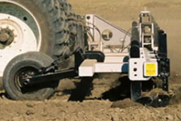 Side view of Wilcox folding bar in use, showing durable frame and soil contact components for consistent tillage performance.